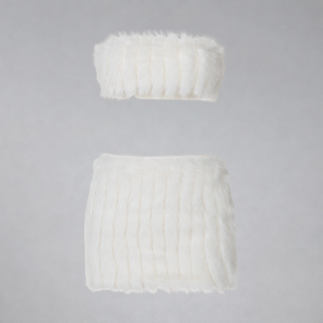 White knit tube top and skirt set on a gray background