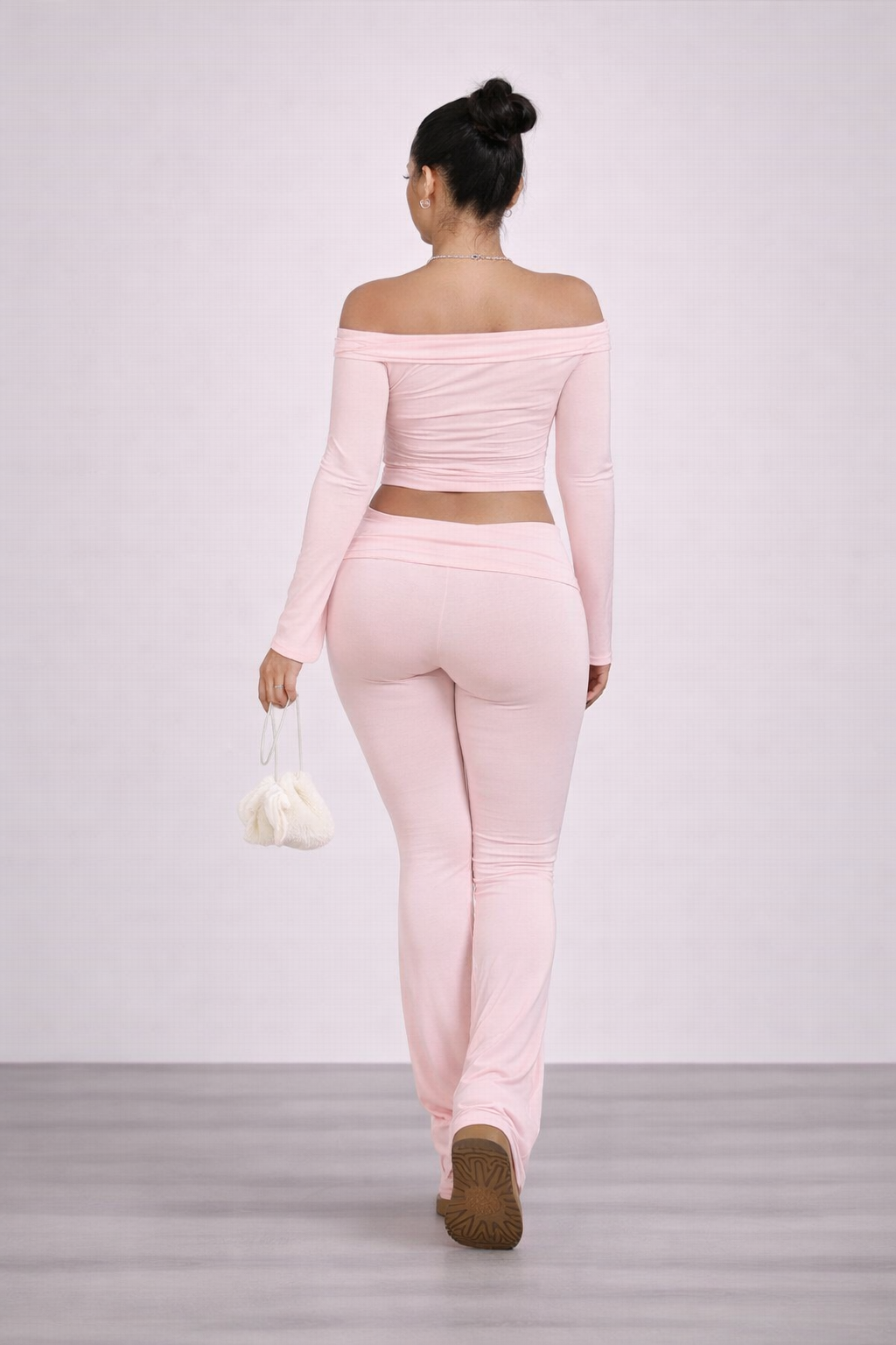 Person wearing a pink matching set on a plain background