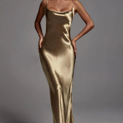 Gold satin slip dress on a model against a gray background