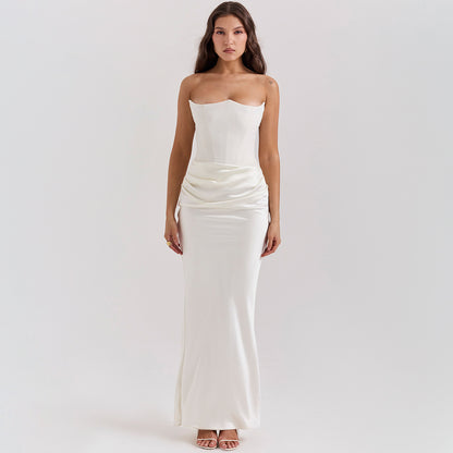 Woman wearing a white strapless gown on a plain background