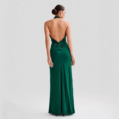 Model wearing a backless halter dress