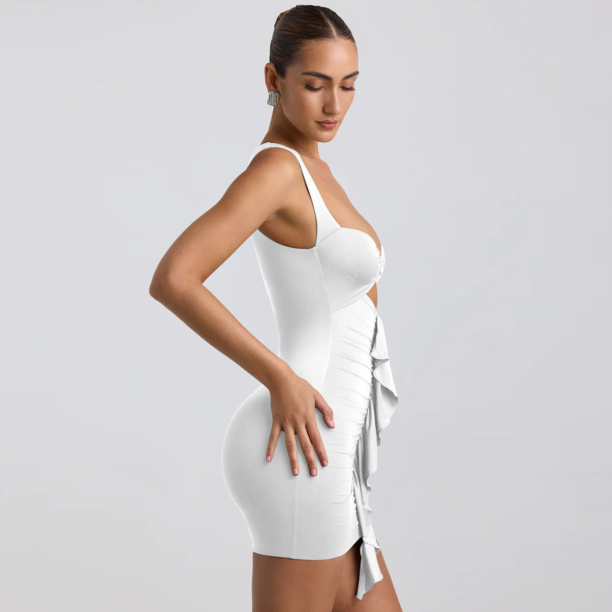 Woman wearing a white dress with a plain background