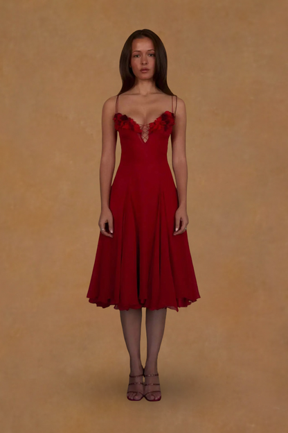 Woman wearing a red dress against a beige background