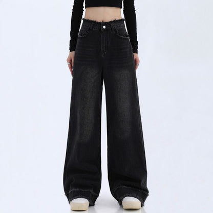 Black wide-leg jeans worn by a person on a white background