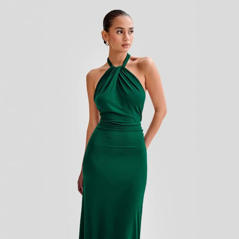 Model wearing a backless halter dress
