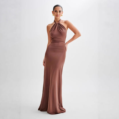Model wearing a backless halter dress