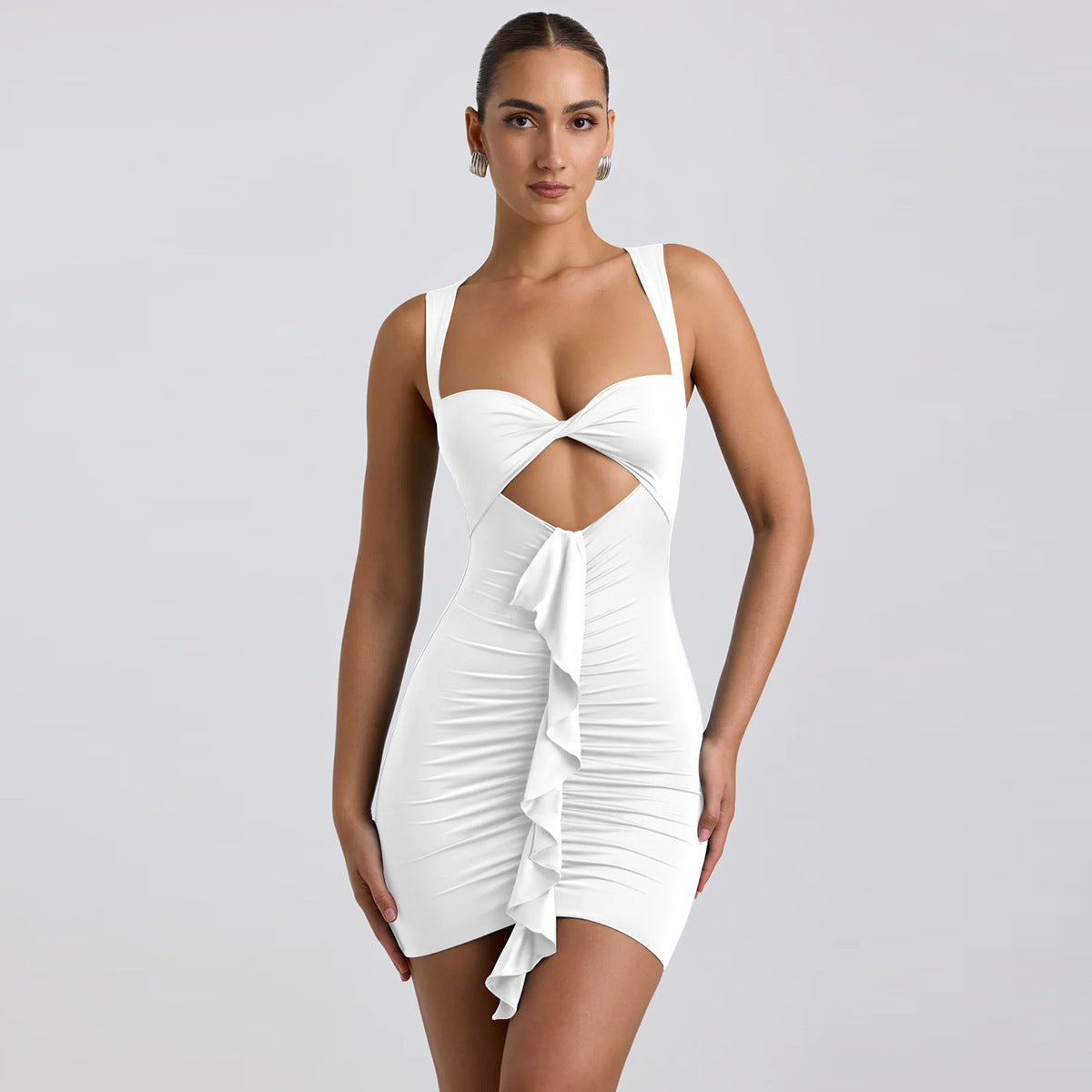 Woman wearing a white dress with cut-out design on a gray background