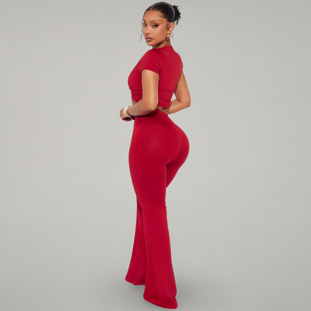 Woman wearing a red jumpsuit on a gray background