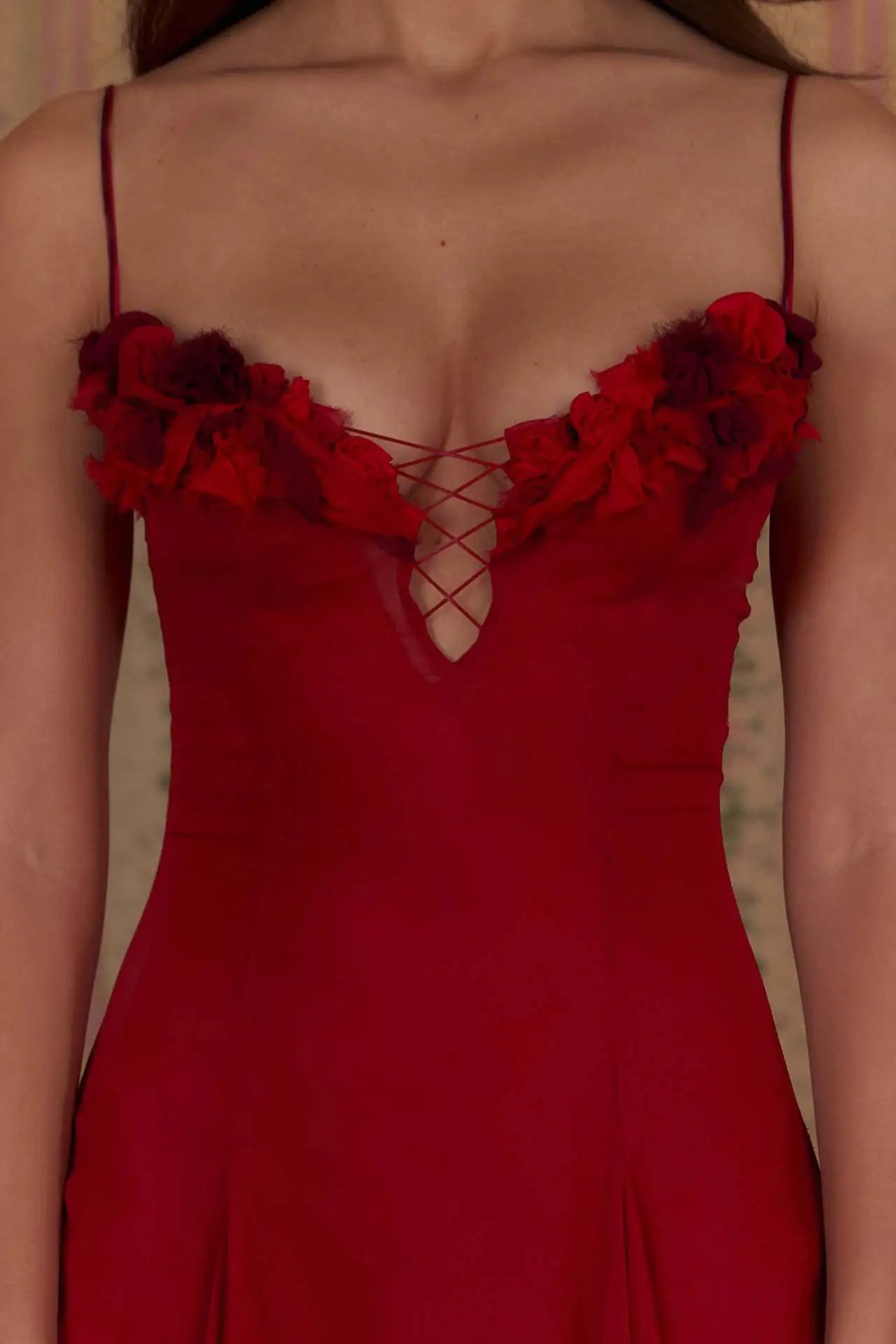 Red dress with floral details on a neutral background