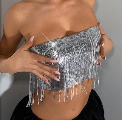 Silver fringe top worn by a person against a neutral background