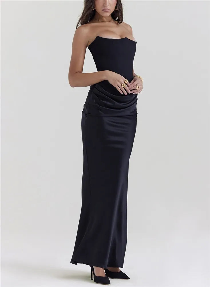 Woman wearing a black strapless gown on a white background
