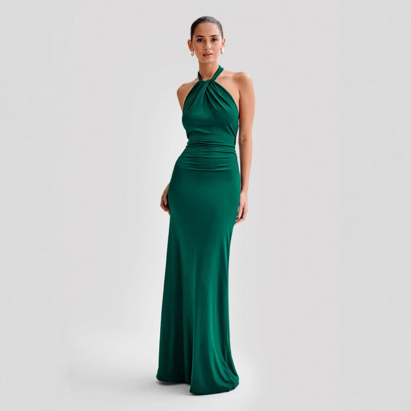 Model wearing a backless halter dress