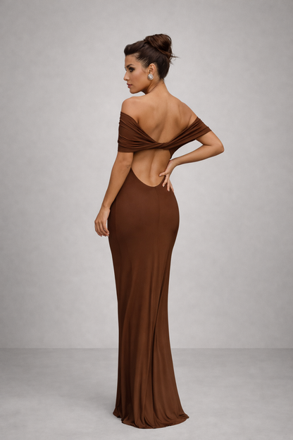 Woman wearing a brown off-shoulder evening gown on a gray background