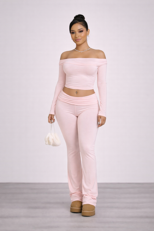 Woman wearing a pink matching set with a white background