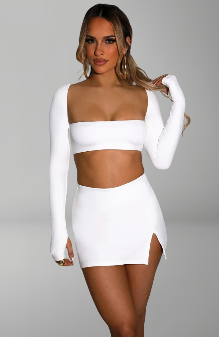 long-sleeve bandeau crop top and mini skirt with side slit for sexy nightlife and party looks.