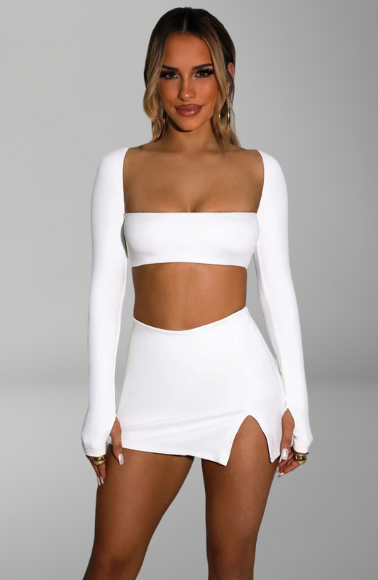 long-sleeve bandeau crop top and mini skirt with side slit for sexy nightlife and party looks.