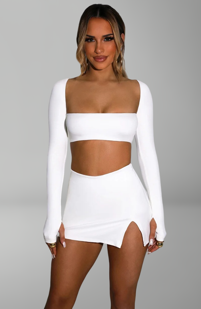 long-sleeve bandeau crop top and mini skirt with side slit for sexy nightlife and party looks.