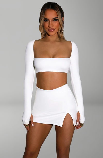 long-sleeve bandeau crop top and mini skirt with side slit for sexy nightlife and party looks.