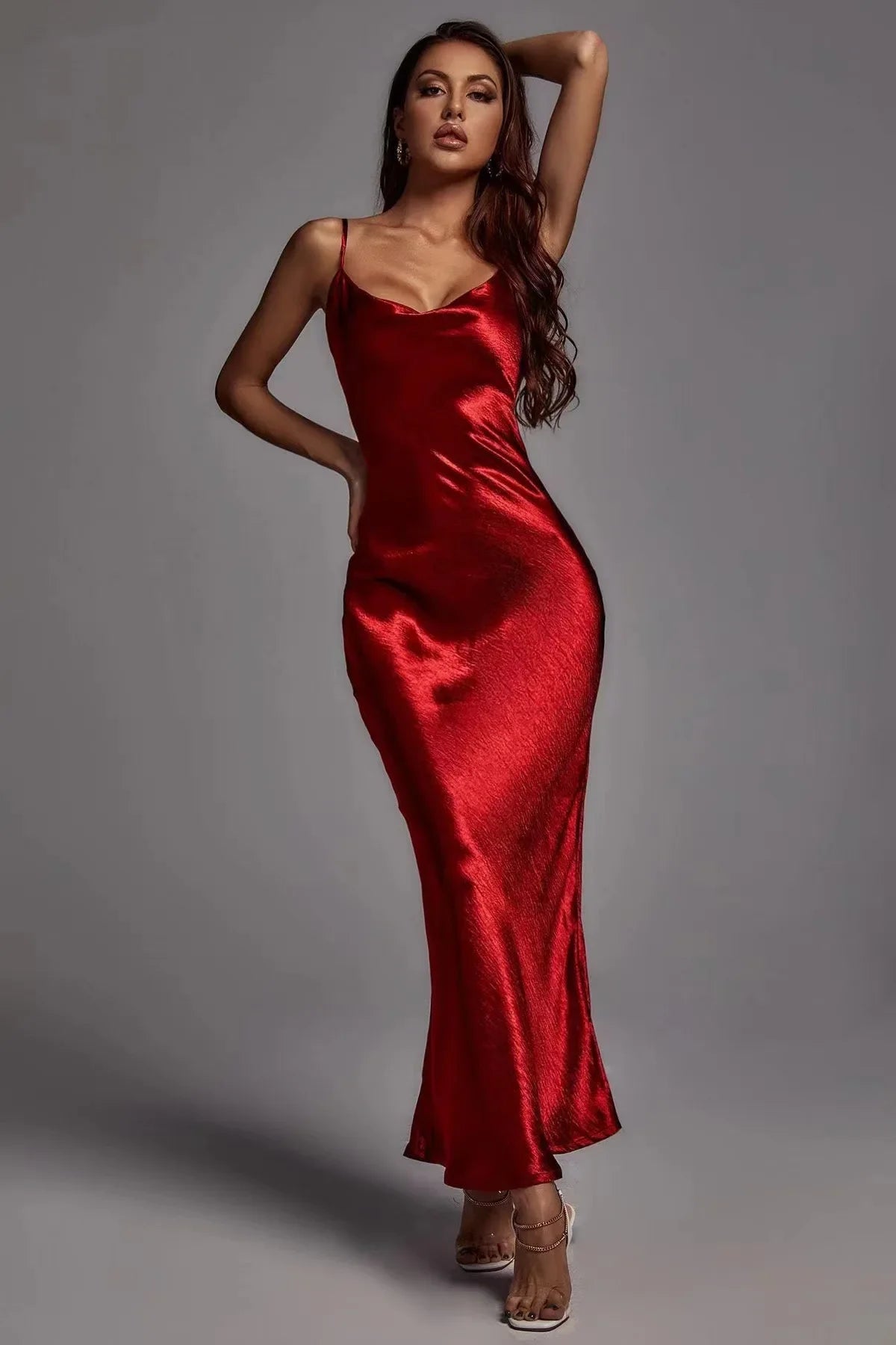 Woman wearing a red satin dress against a gray background
