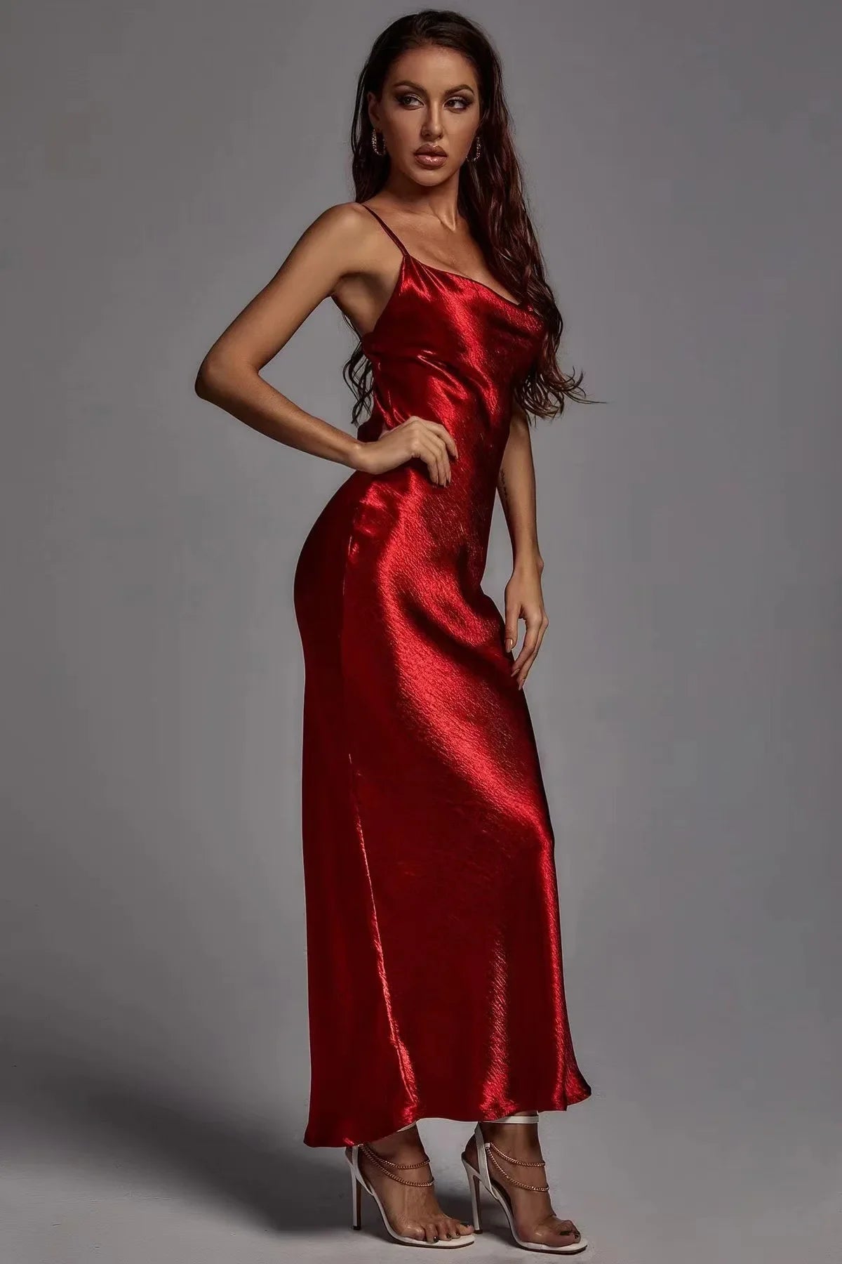 Woman wearing a red satin dress against a gray background