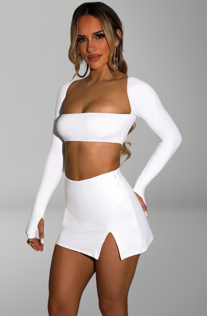 long-sleeve bandeau crop top and mini skirt with side slit for sexy nightlife and party looks.