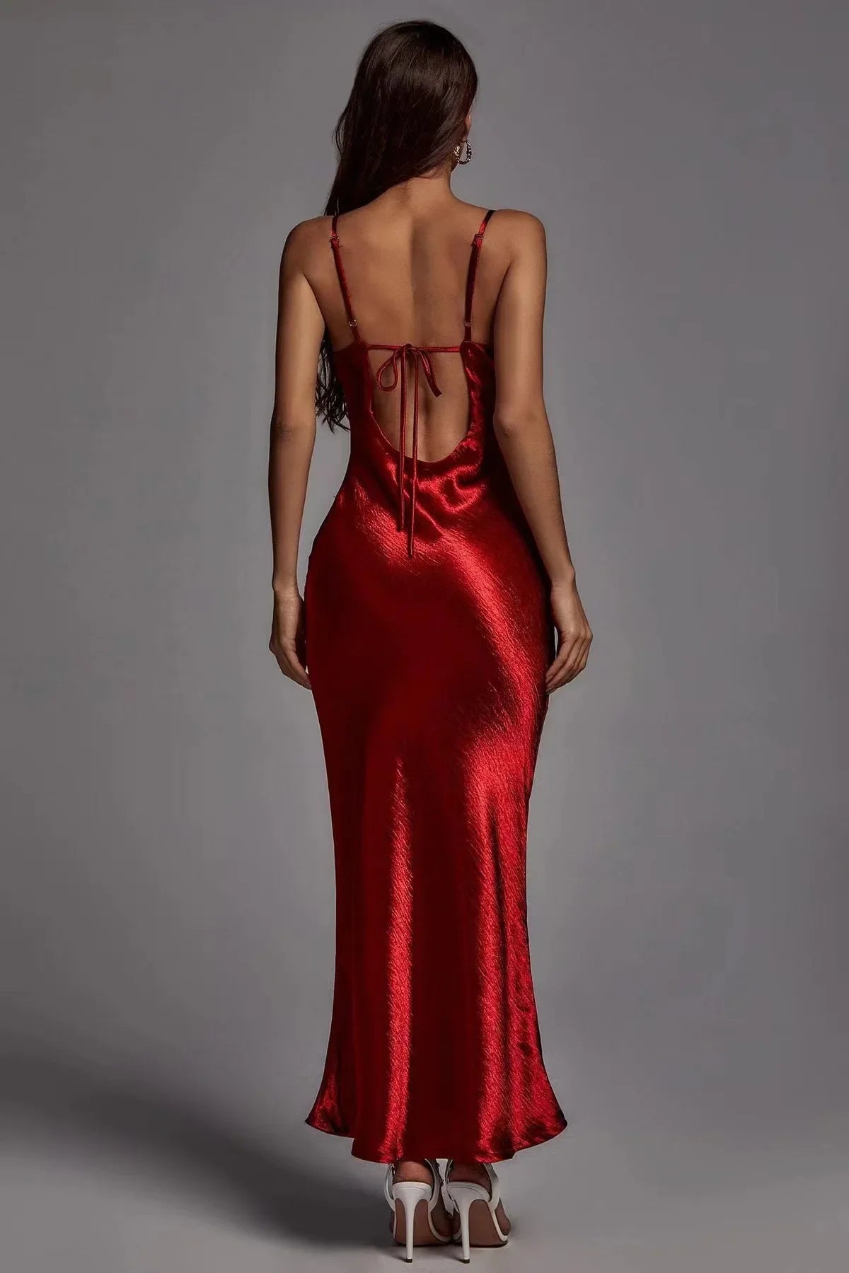 Red satin dress with open back on a gray background