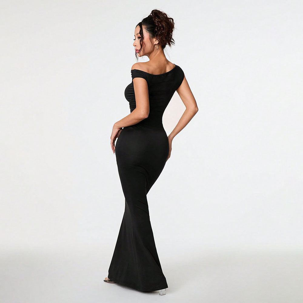 Woman wearing a black evening gown on a white background