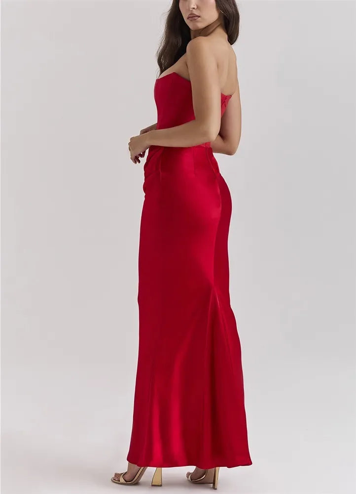 Woman wearing a red strapless gown on a white background