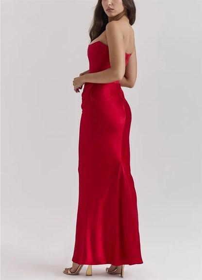 Woman wearing a red strapless gown on a white background