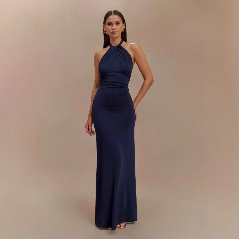 Model wearing a backless halter dress