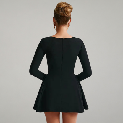 Black dress with long sleeves on a plain background