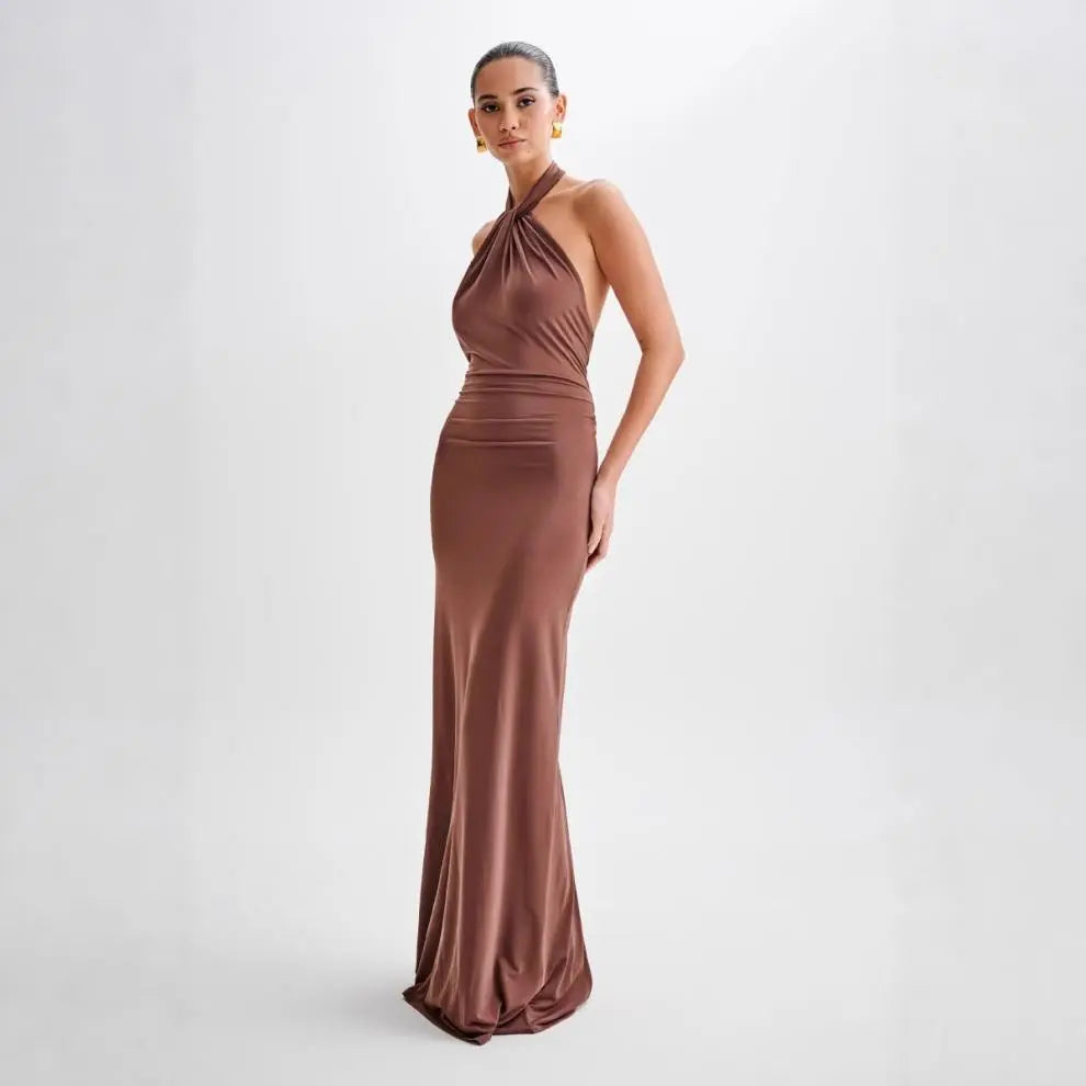 Model wearing a backless halter dress