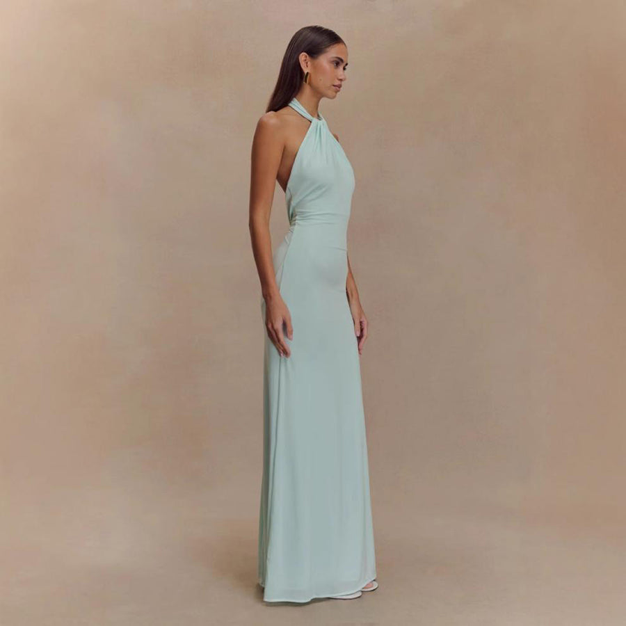 Model wearing a backless halter dress
