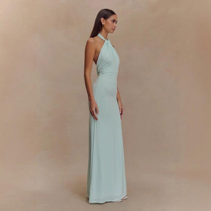 Model wearing a backless halter dress