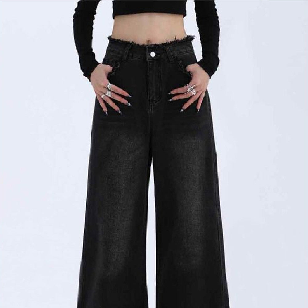 Black wide-leg jeans worn by a person on a white background