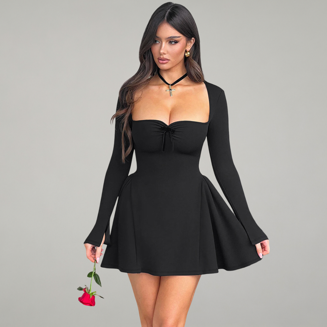 Woman wearing a black dress holding a red rose against a gray background