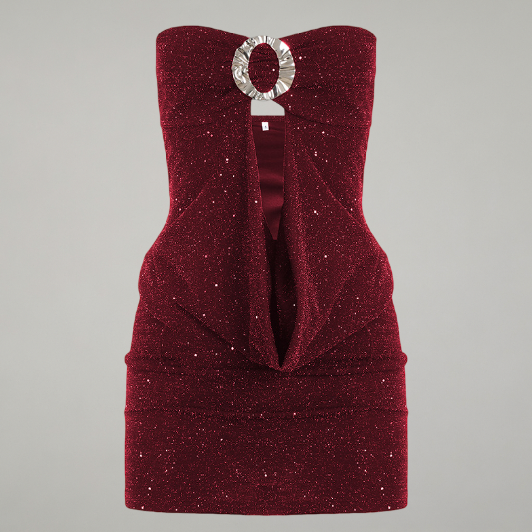 Red strapless dress with a silver circular brooch on a gray background