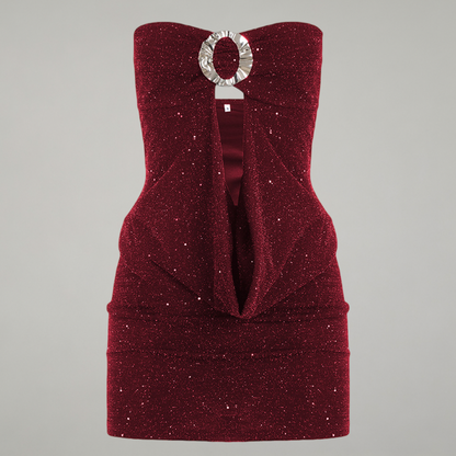 Red strapless dress with a silver circular brooch on a gray background