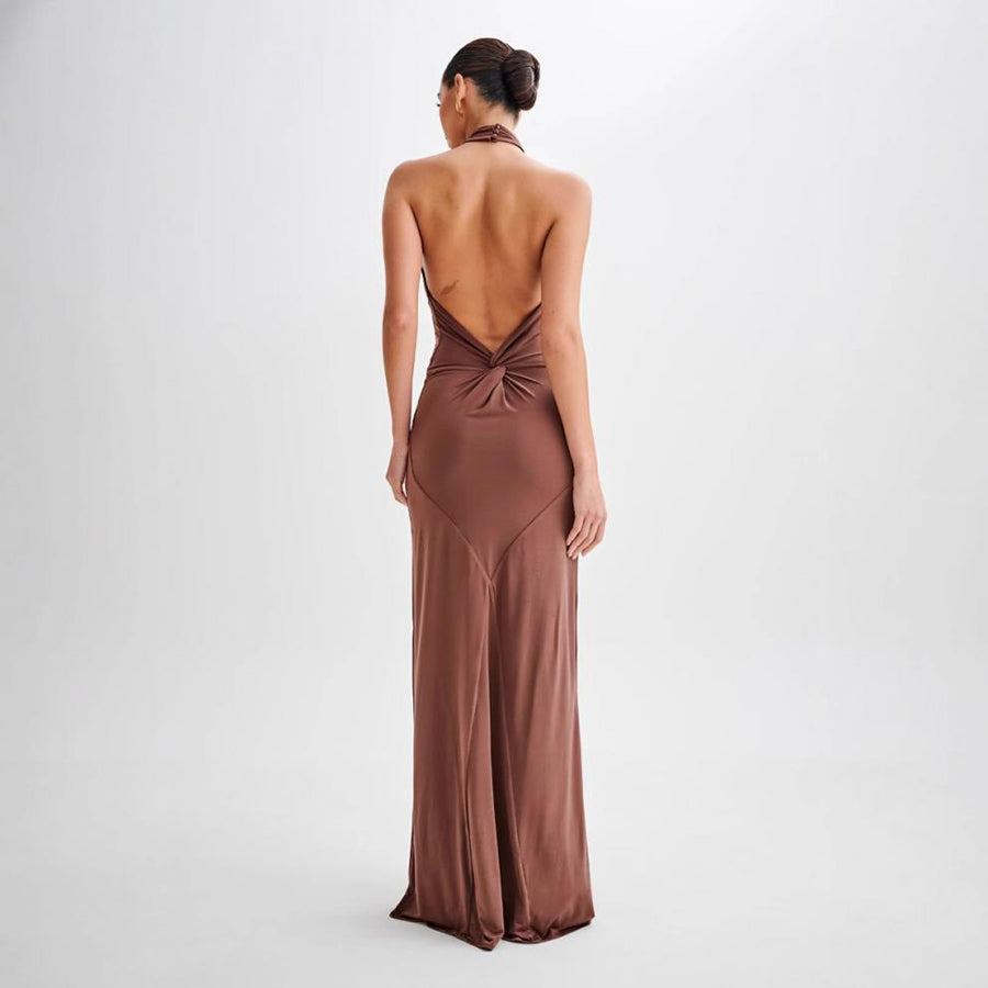 Model wearing a backless halter dress