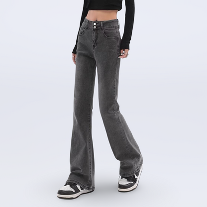 Person wearing flared jeans on a white background